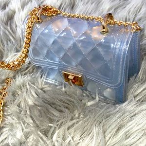 Chic mini clutch purse with gold accents.
